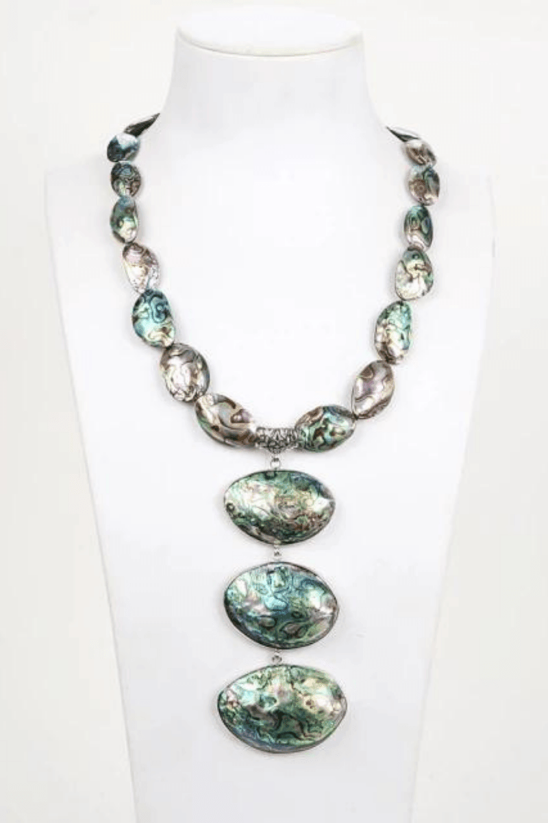 a round necklace of small abalone shells with three large shells attached in the front.
