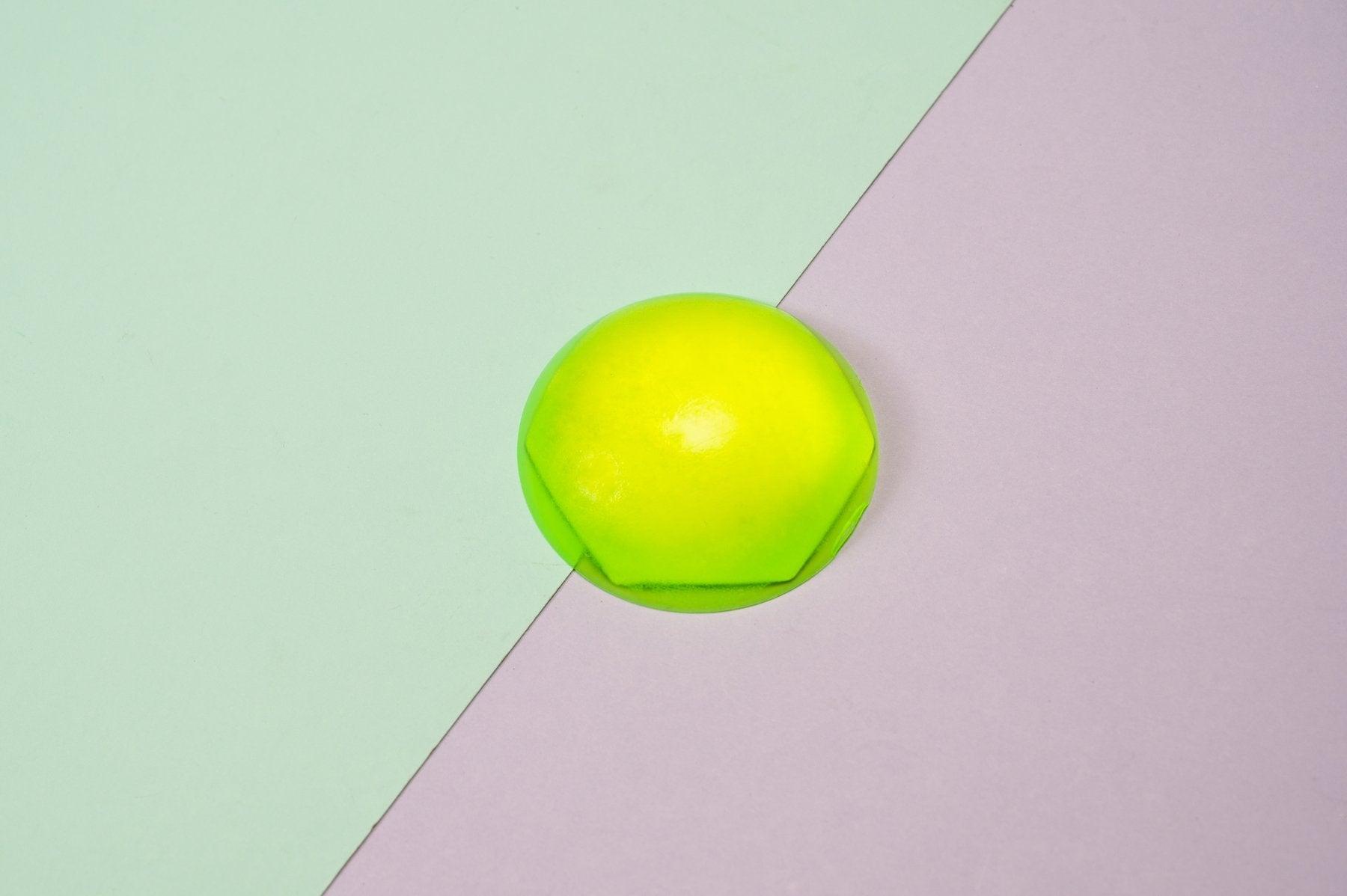 A small green geometric shaped resin dome.