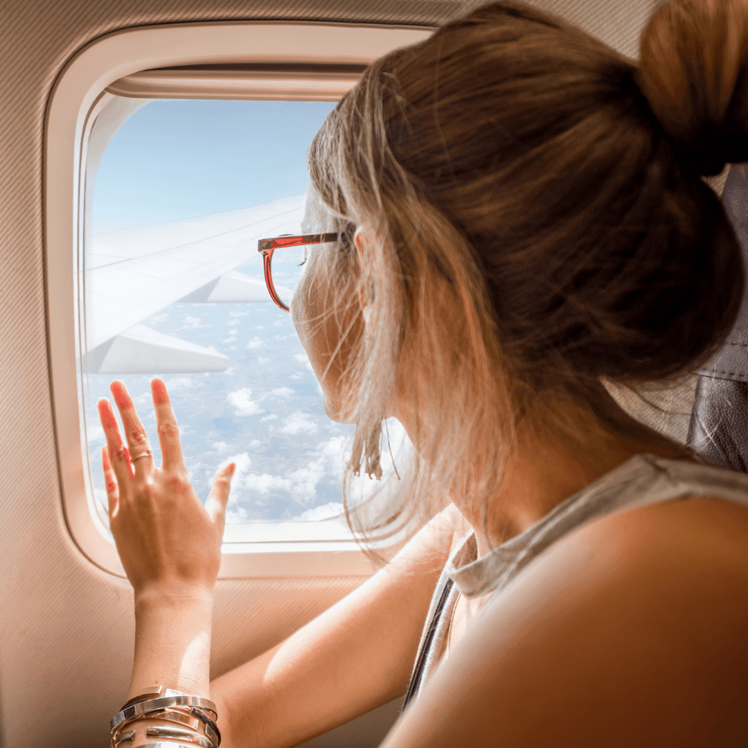 A woman looking out an airplane window