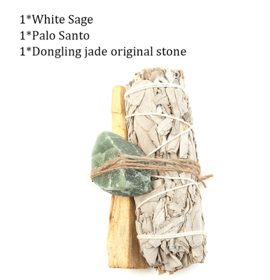 A natural wood support holding up an abalone shell with a sage stick with a feather placed beside